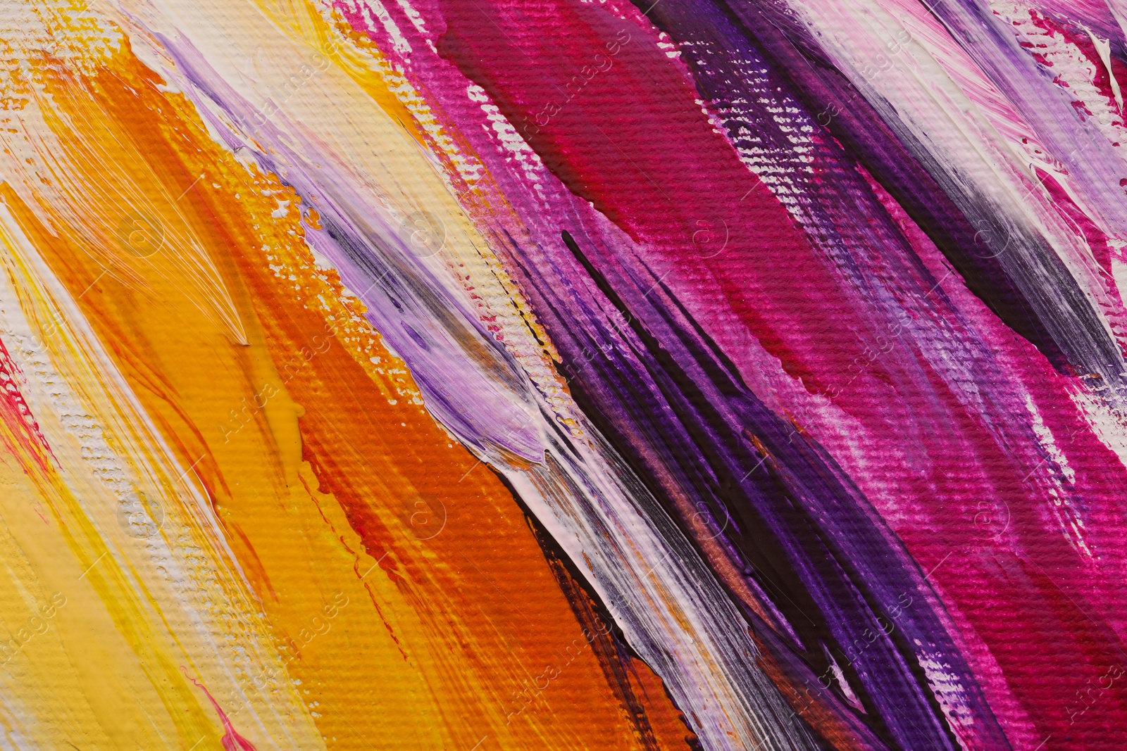 Photo of Beautiful strokes of colorful oil paints on white canvas as background, closeup