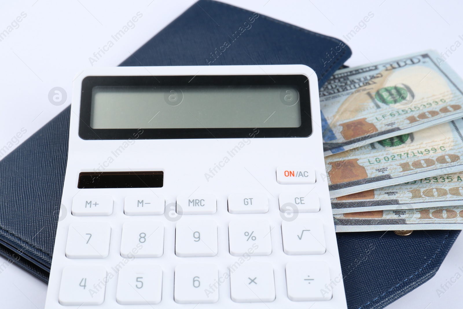 Photo of Calculator, dollar banknotes and wallet on white background, closeup. Retirement concept