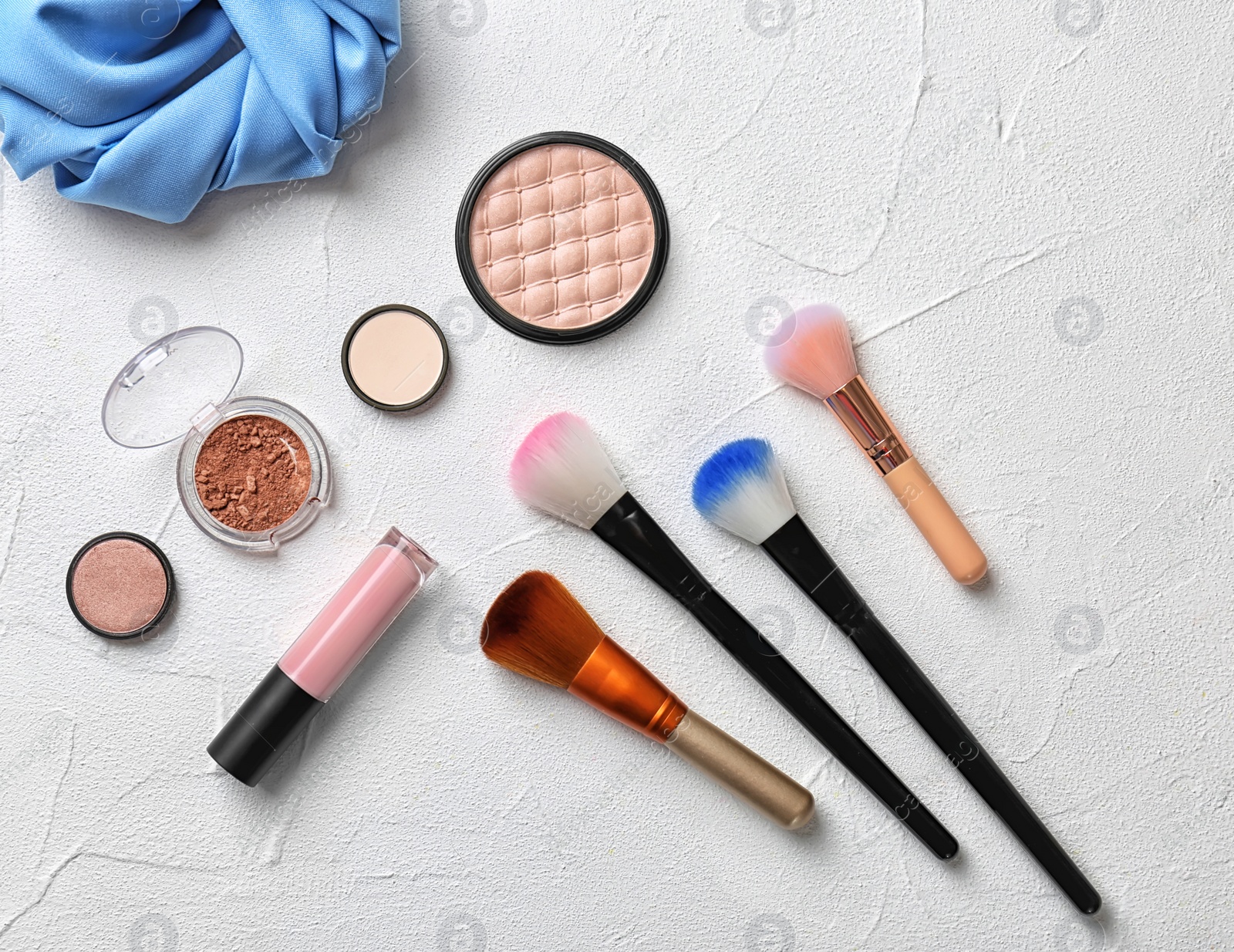 Photo of Flat lay composition with cosmetic products and makeup brushes on light background