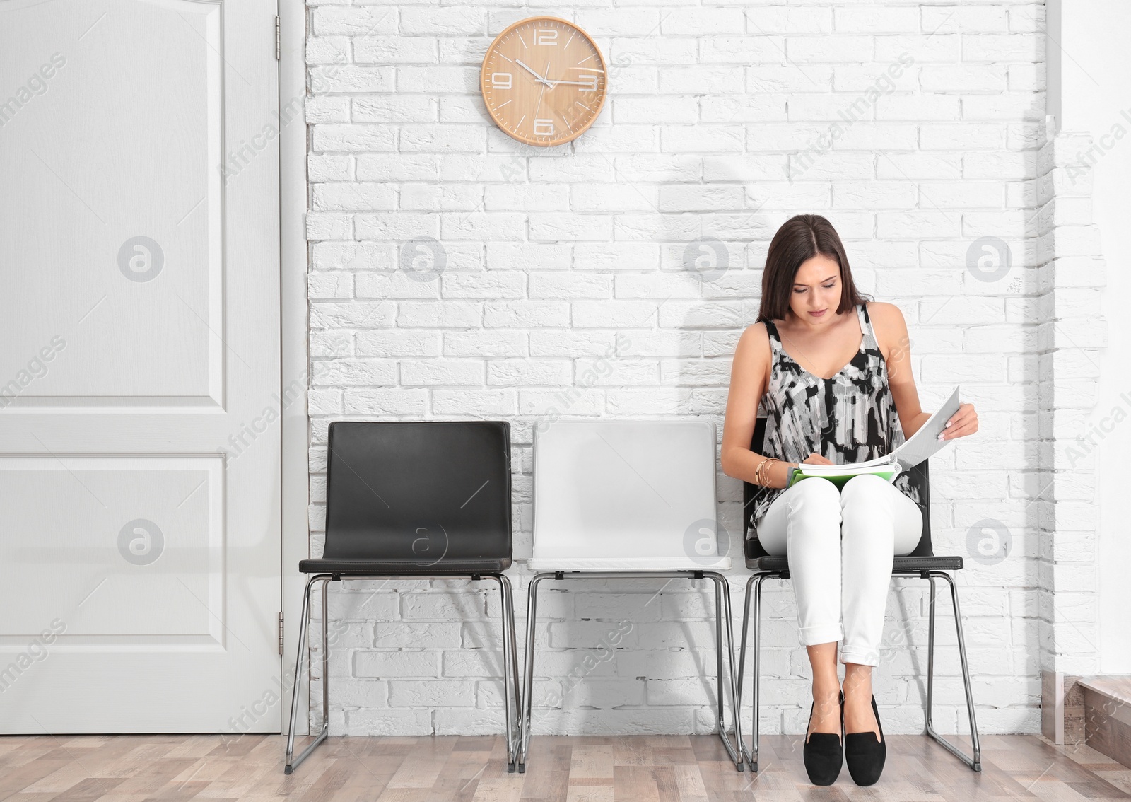 Photo of Young woman waiting for job interview, indoors