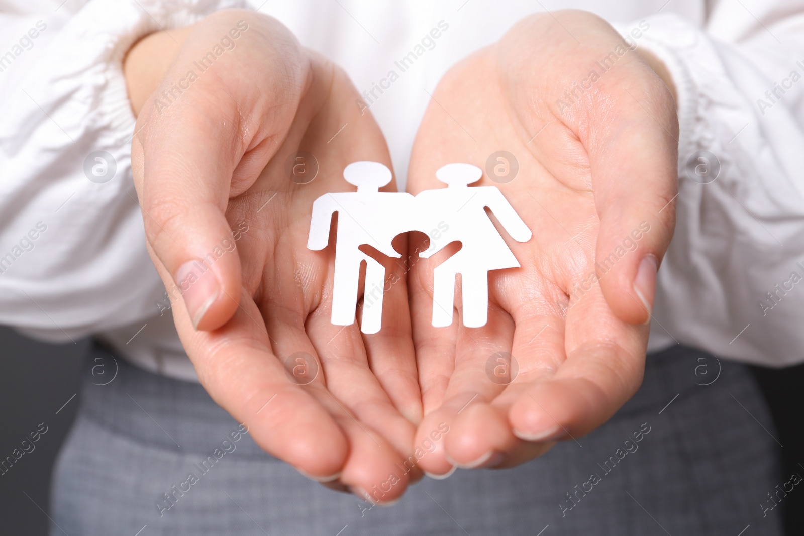 Photo of Woman holding cutout paper family, closeup. Life insurance concept