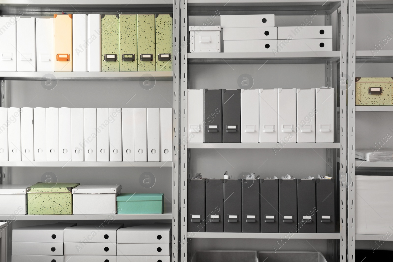 Photo of Folders with documents on shelves in archive