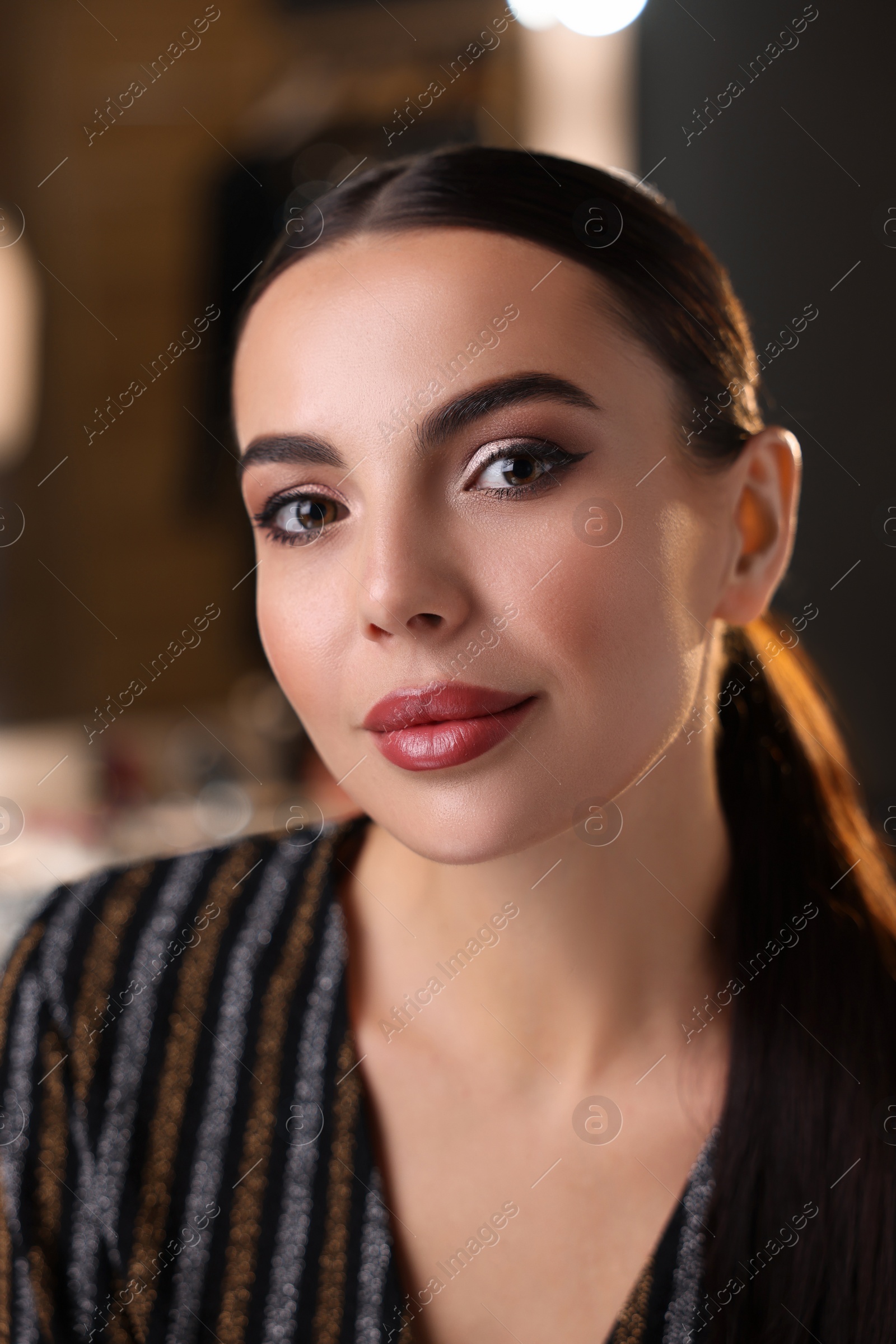 Photo of Beautiful woman wearing makeup in dressing room