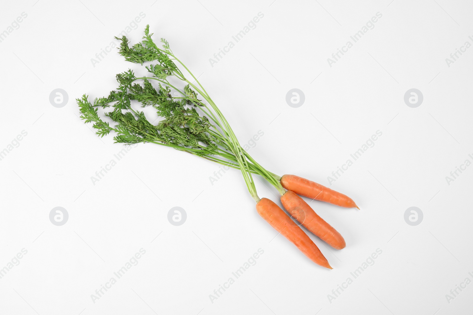 Photo of Ripe carrots on white background. Healthy diet