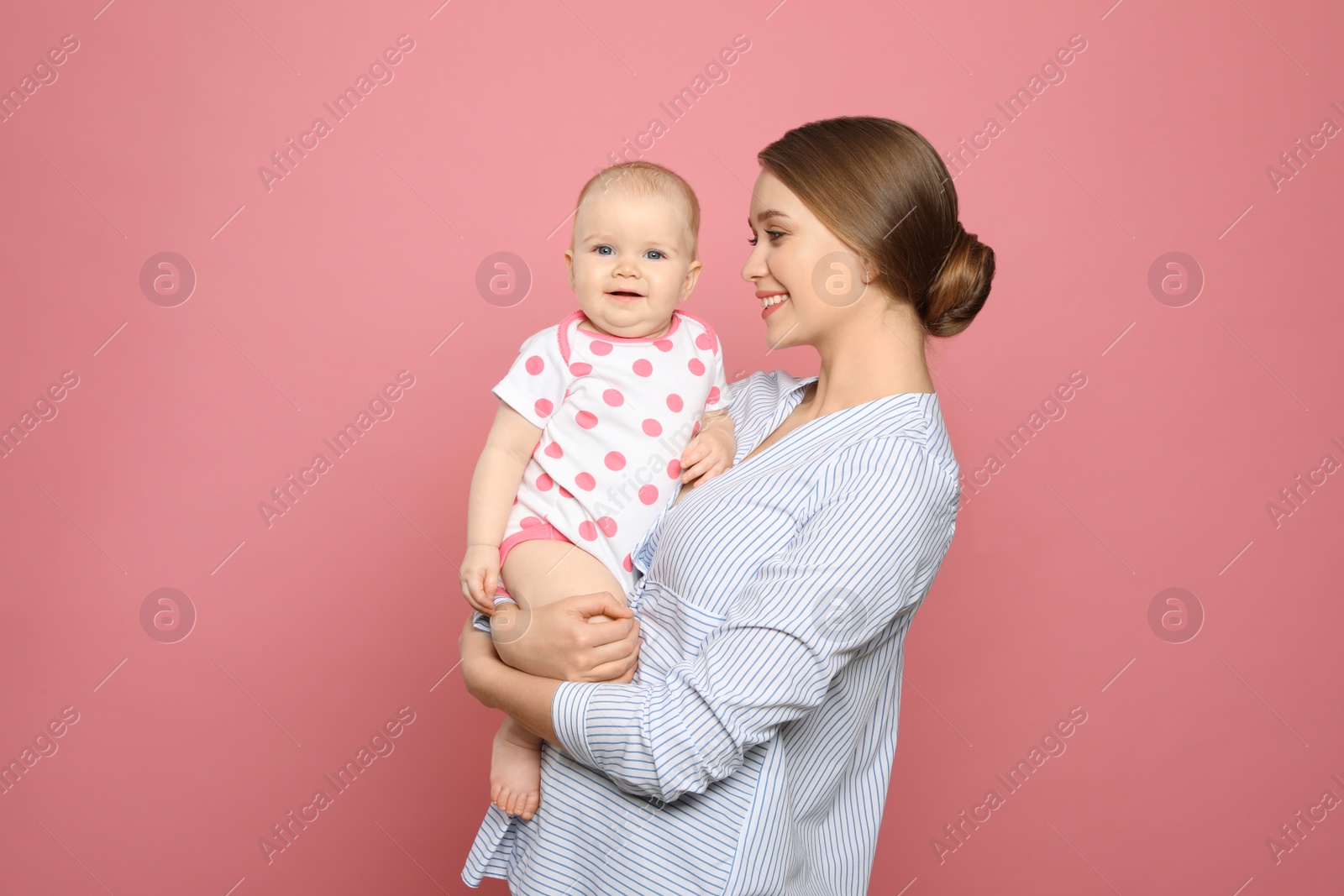 Photo of Portrait of happy mother with her baby on color background