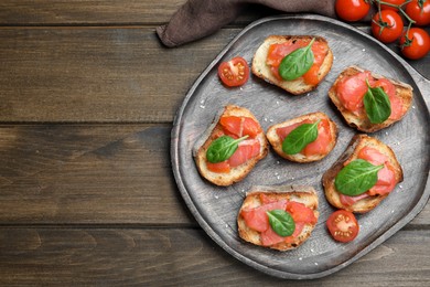 Photo of Delicious sandwiches with salmon and spinach on wooden table, flat lay. Space for text