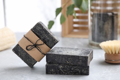 Natural tar soap on light grey table