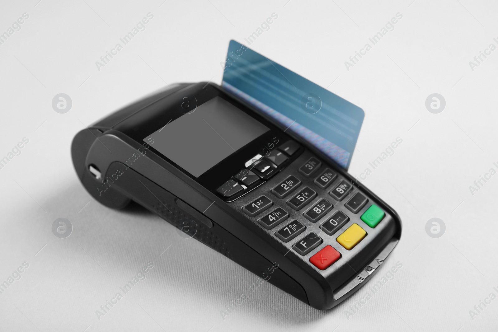 Photo of Modern payment terminal with credit card on grey background