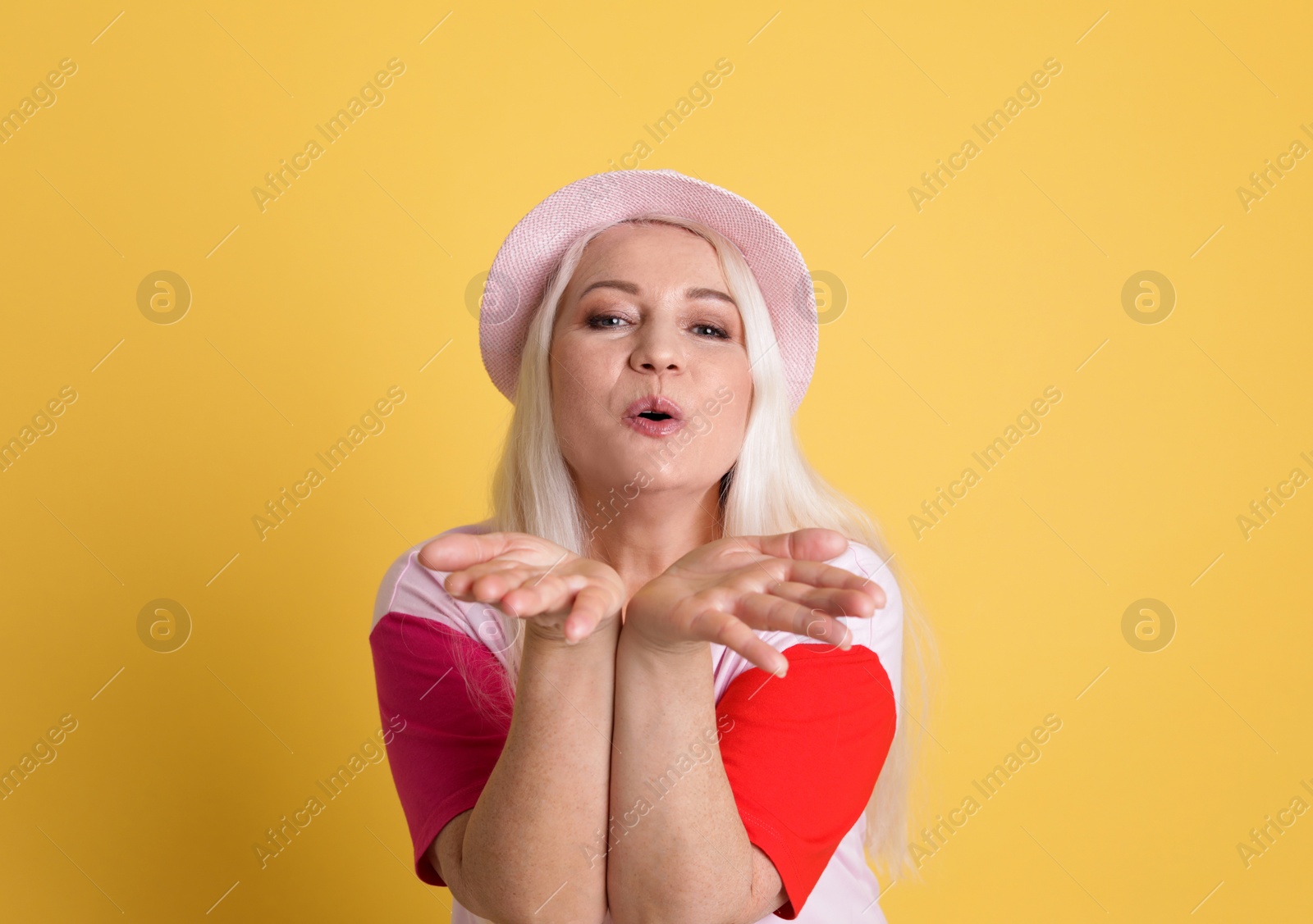 Photo of Portrait of mature woman in hipster outfit on color background