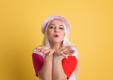 Photo of Portrait of mature woman in hipster outfit on color background