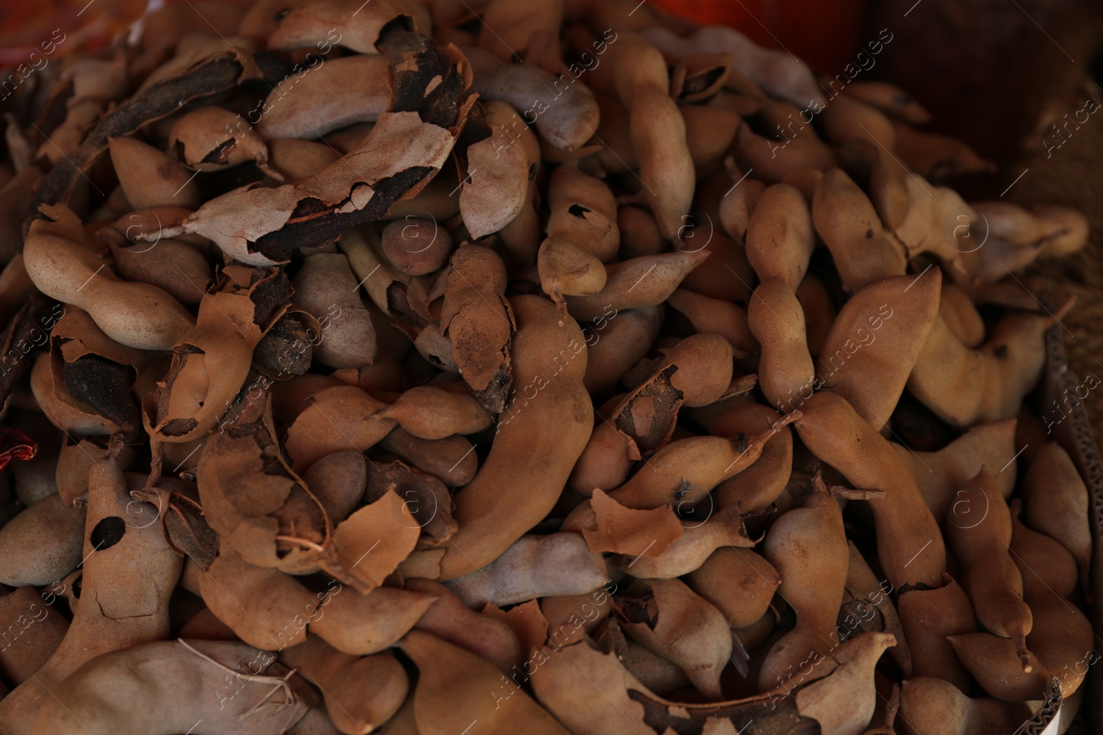 Photo of Heap of delicious tamarinds on counter at market, above view