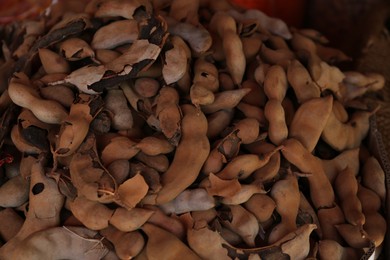 Photo of Heap of delicious tamarinds on counter at market, above view