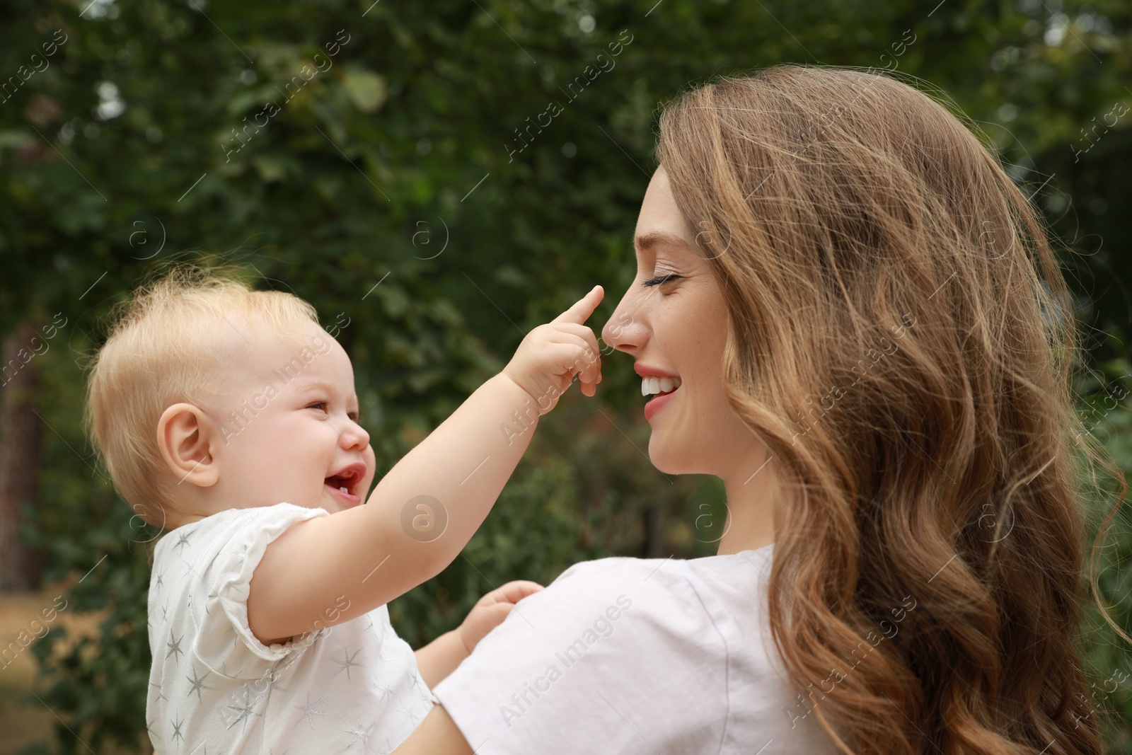 Photo of Mother with her cute baby spending time together outdoors