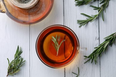 Photo of Aromatic herbal tea with rosemary on white wooden table, flat lay