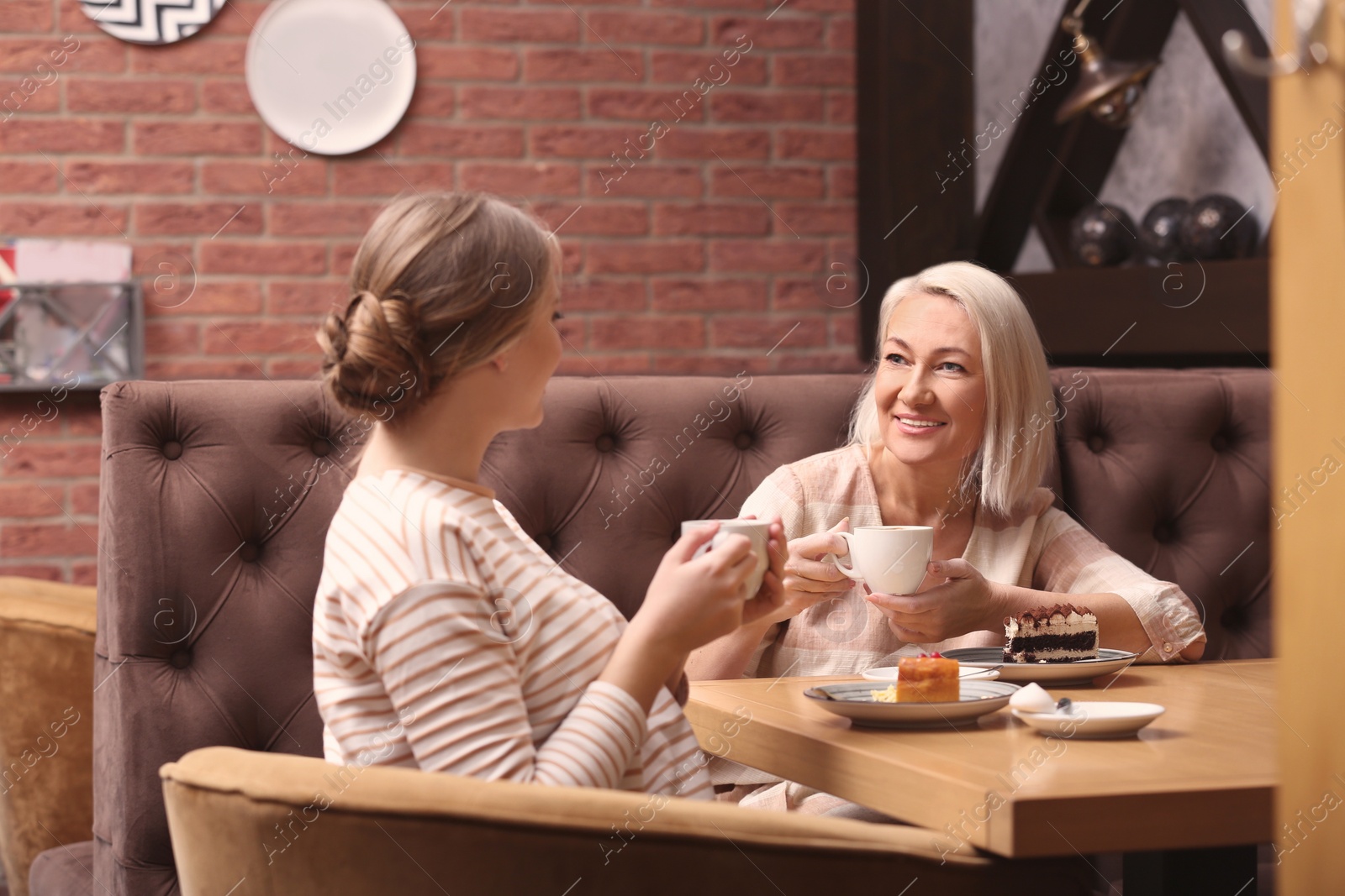 Photo of Mother and her adult daughter spending time together in cafe