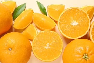 Flat lay composition with ripe oranges on color background