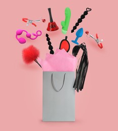 DIfferent sex toys and accessories falling into paper shopping bag on pink background