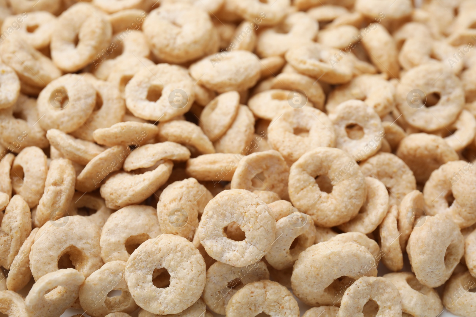 Photo of Tasty sweet cereal rings as background, closeup