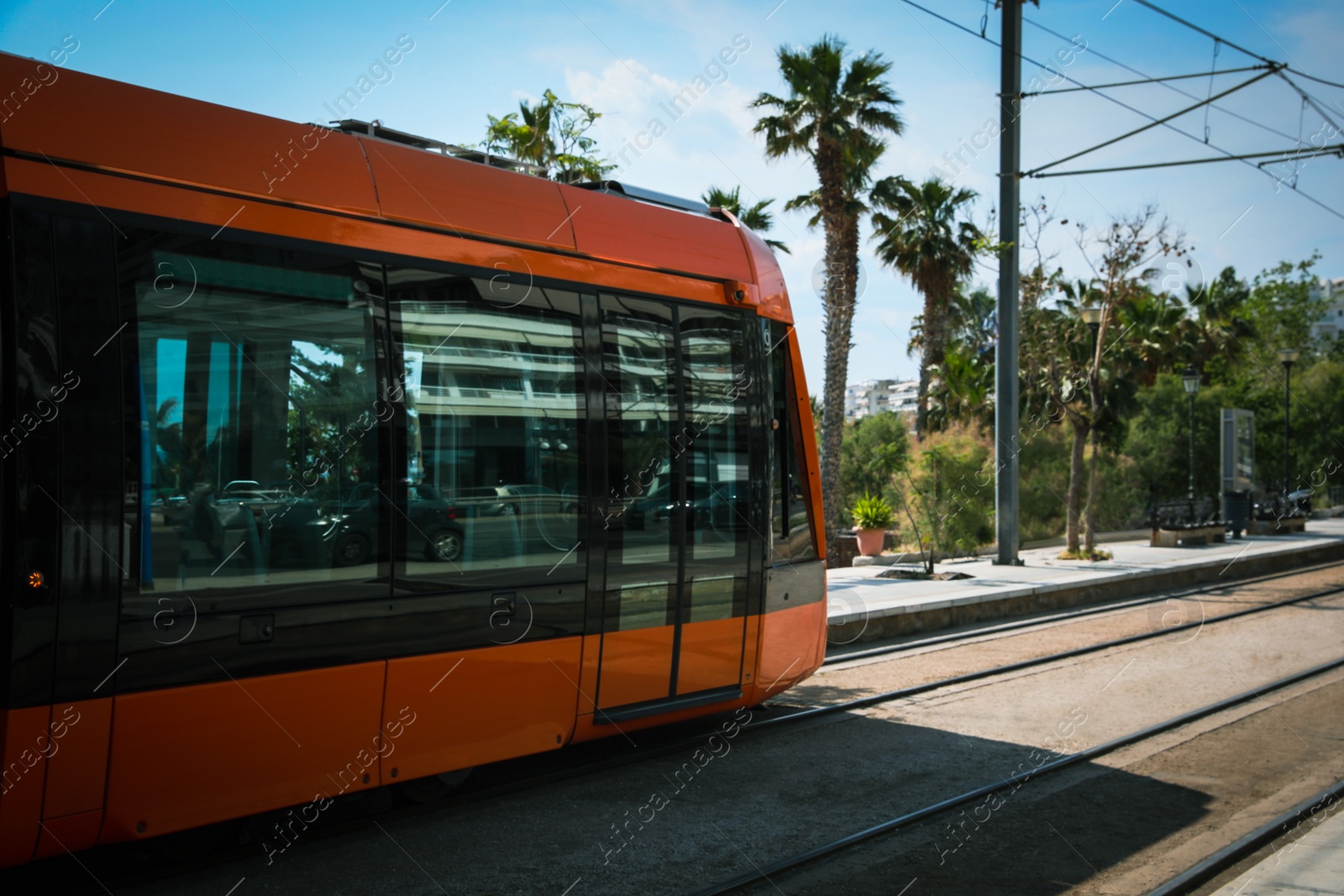 Photo of Modern tram on city street. Public transport