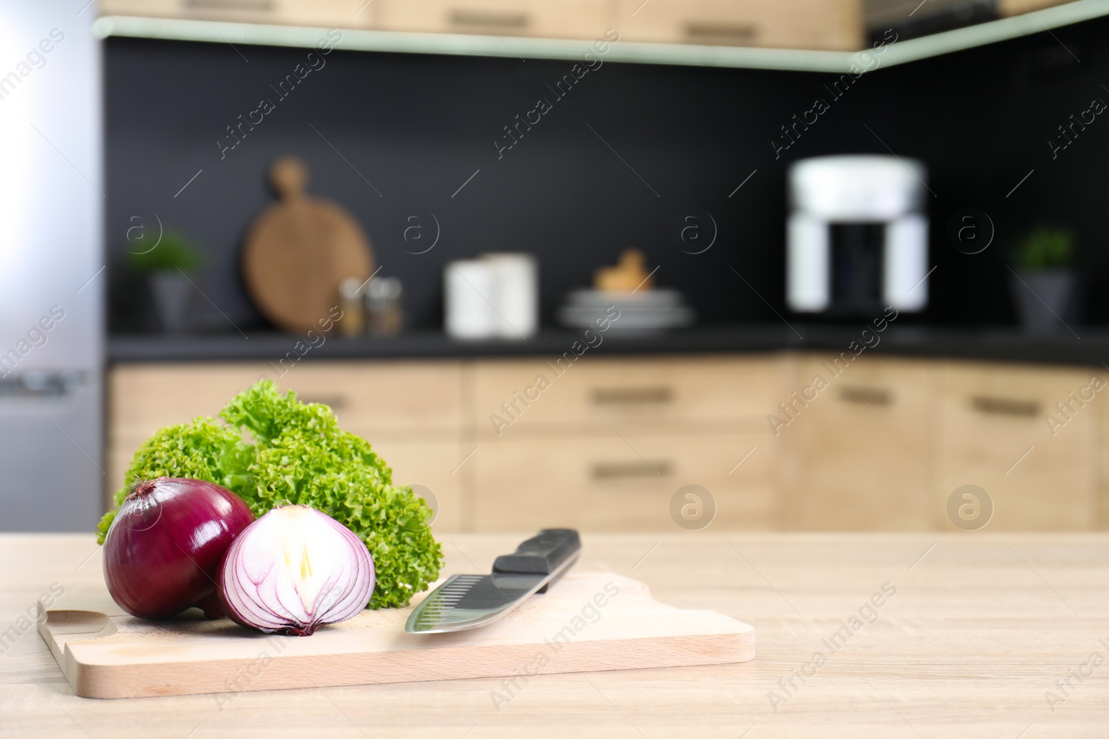 Photo of Fresh vegetables on wooden table in kitchen. Space for text