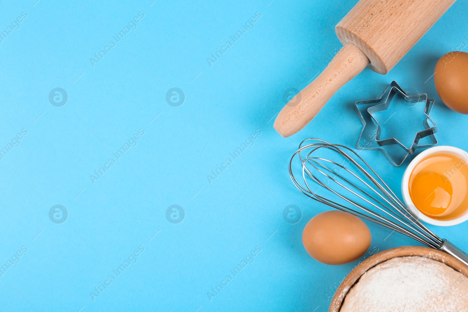 Photo of Flat lay composition with eggs and other ingredients on light blue background, space for text. Baking pie