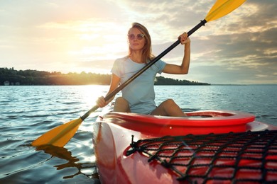 Beautiful woman kayaking on river. Summer activity