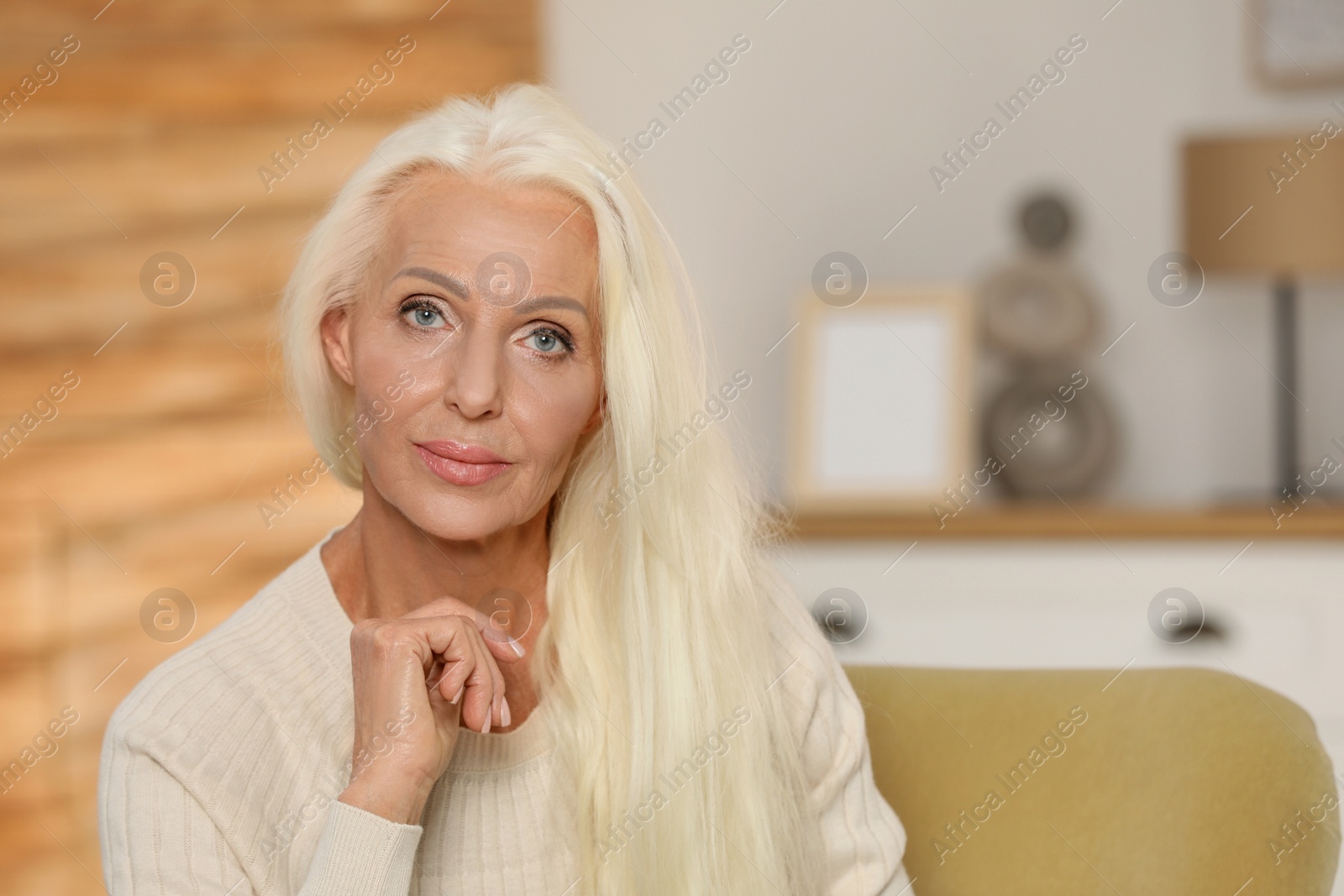 Photo of Portrait of elegant mature woman at home. Space for text