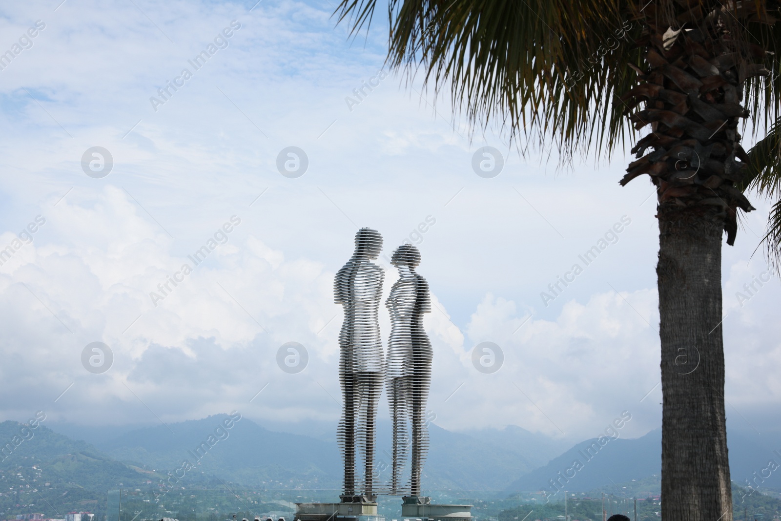 Photo of BATUMI, GEORGIA - JUNE 14, 2022: Movable sculptural composition Ali and Nino with breathtaking landscape on background