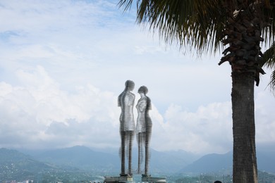 BATUMI, GEORGIA - JUNE 14, 2022: Movable sculptural composition Ali and Nino with breathtaking landscape on background