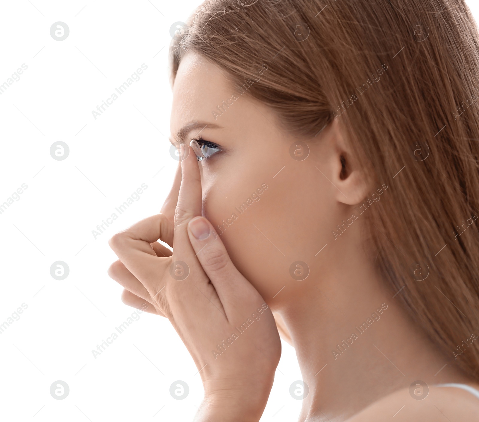 Photo of Young woman putting contact lens on white background