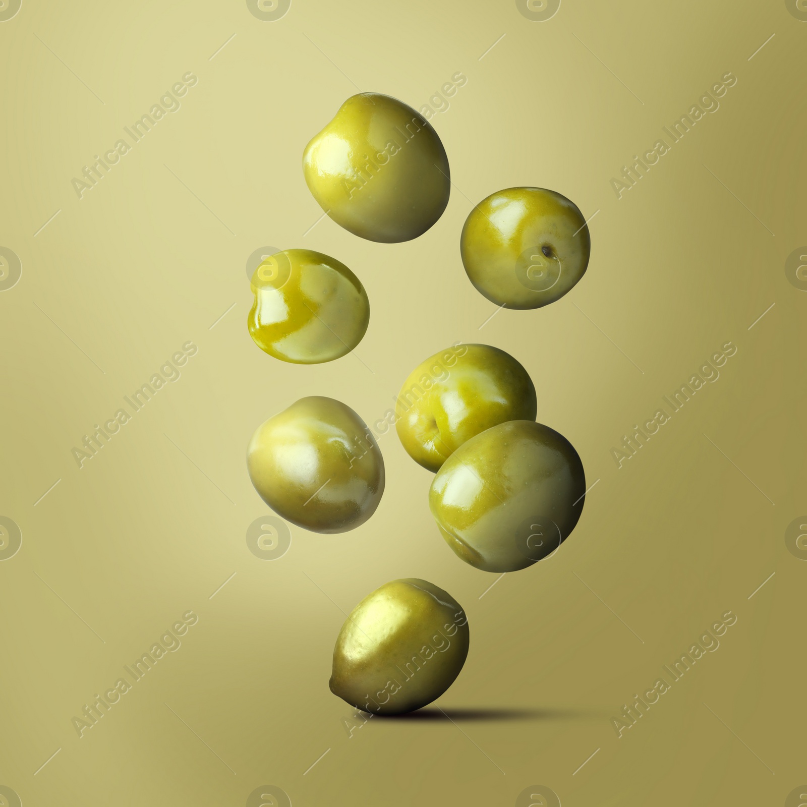 Image of Fresh ripe olives falling on olive background