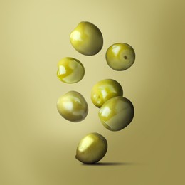 Image of Fresh ripe olives falling on olive background