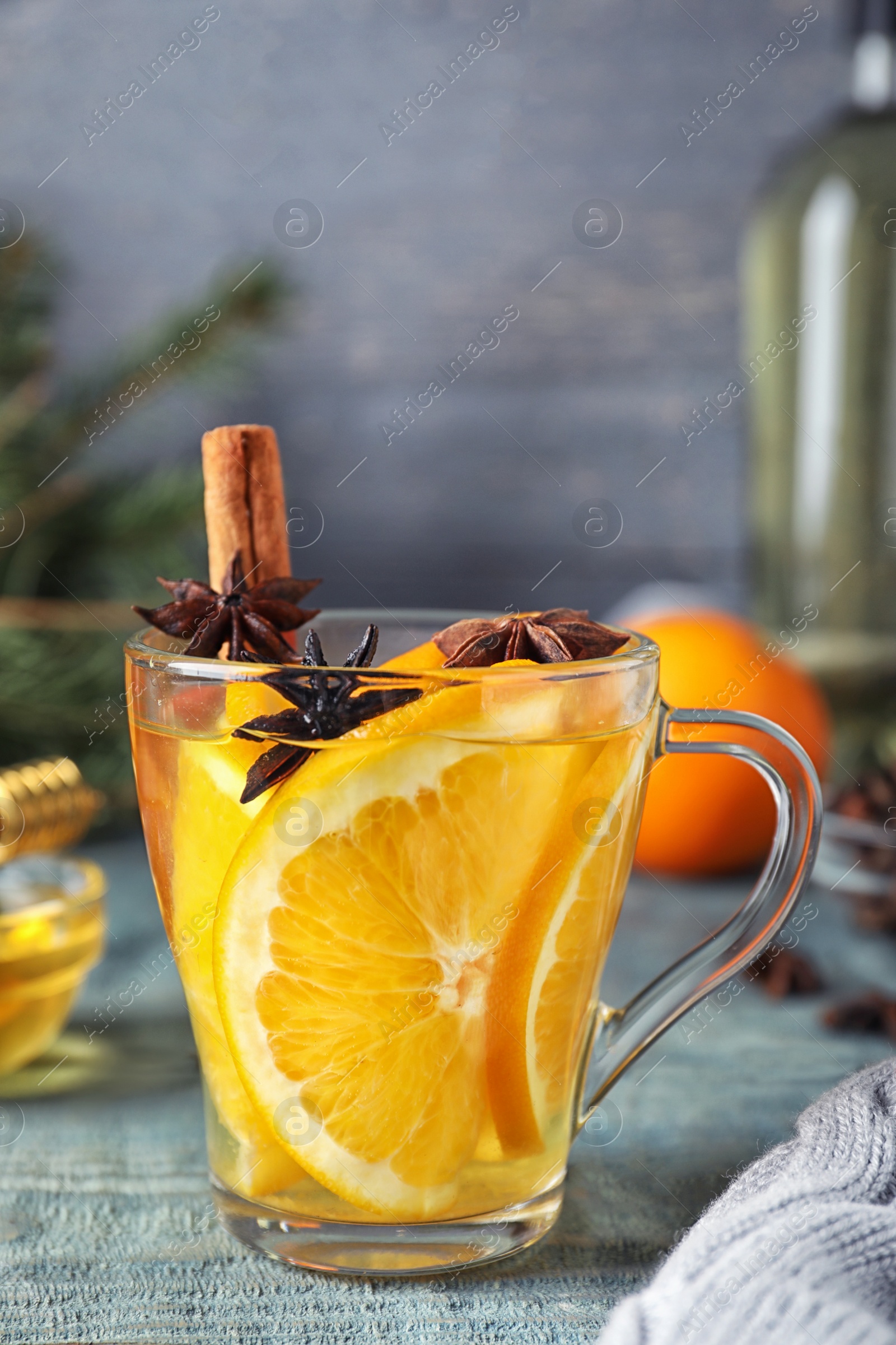 Photo of Aromatic mulled wine on light blue wooden table