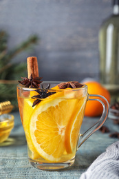 Photo of Aromatic mulled wine on light blue wooden table