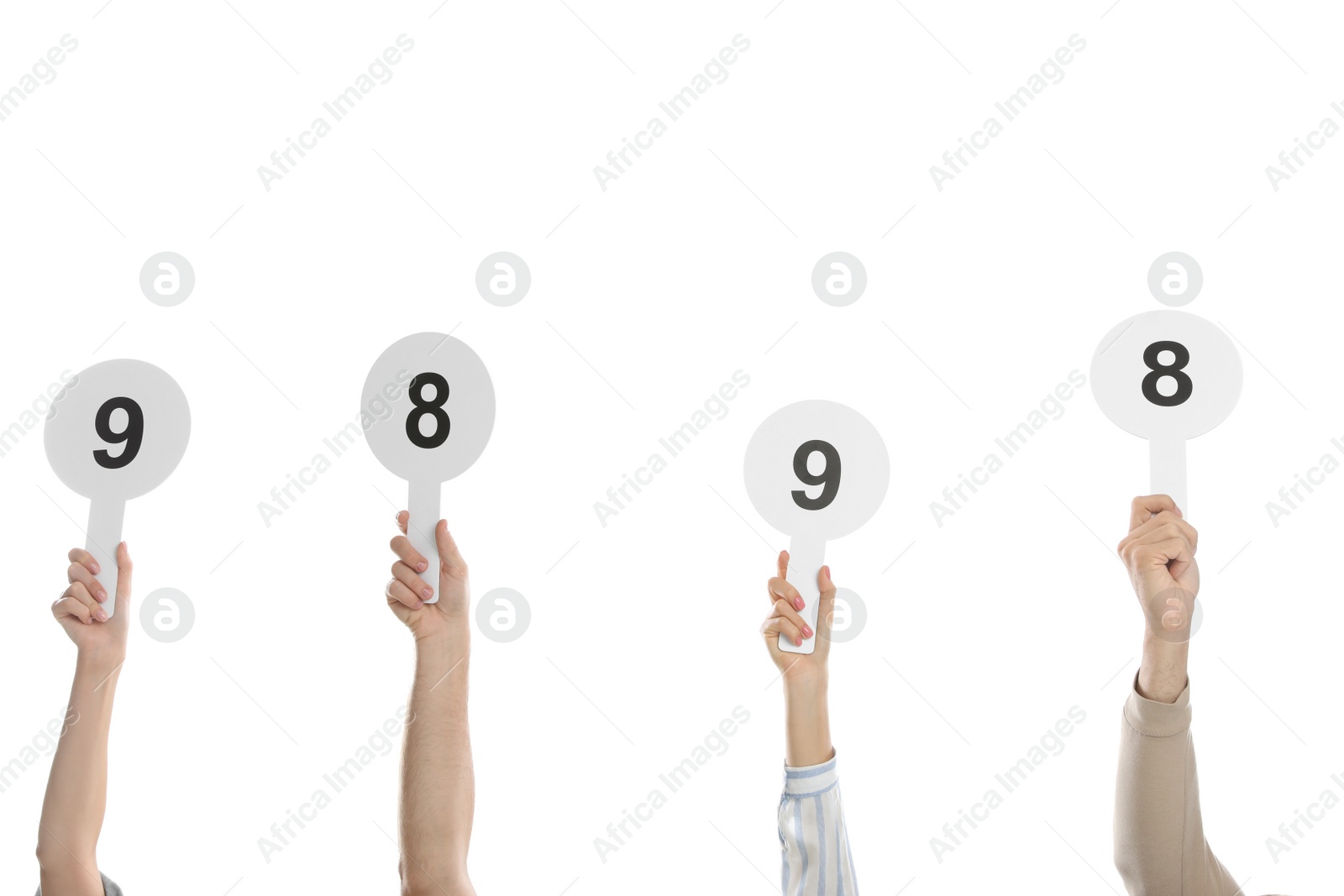 Photo of Panel of judges holding different score signs on white background, closeup