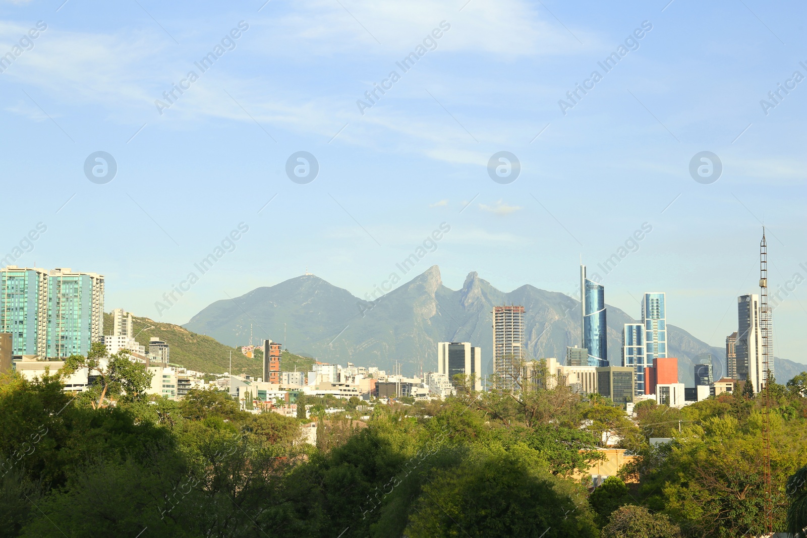 Photo of Picturesque view of mountains and city with skyscrapers