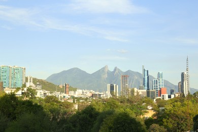 Picturesque view of mountains and city with skyscrapers