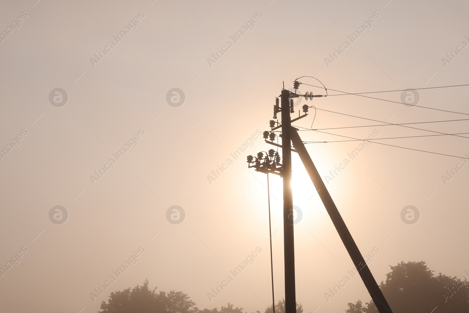Photo of Utility pole with electric cables outdoors on summer day. Space for text
