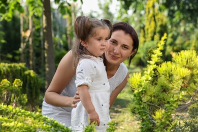 Photo of Mother with her cute daughter spending time together in park