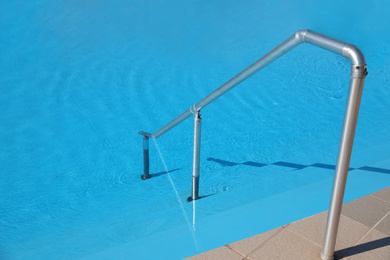 Photo of Modern swimming pool with step ladder. Summer vacation