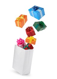 Image of Many different gift boxes falling into paper shopping bag on white background