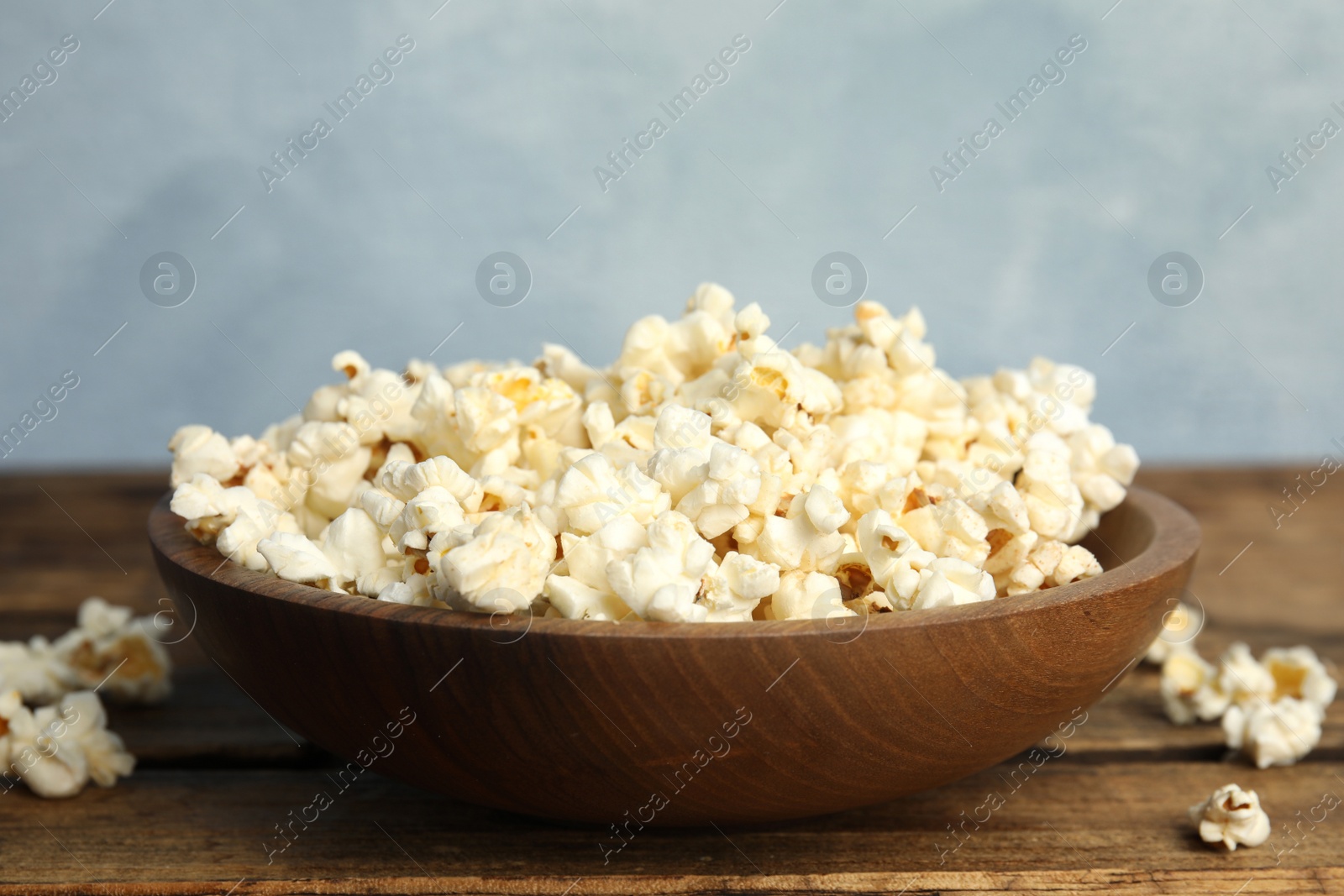 Photo of Tasty fresh pop corn on wooden table