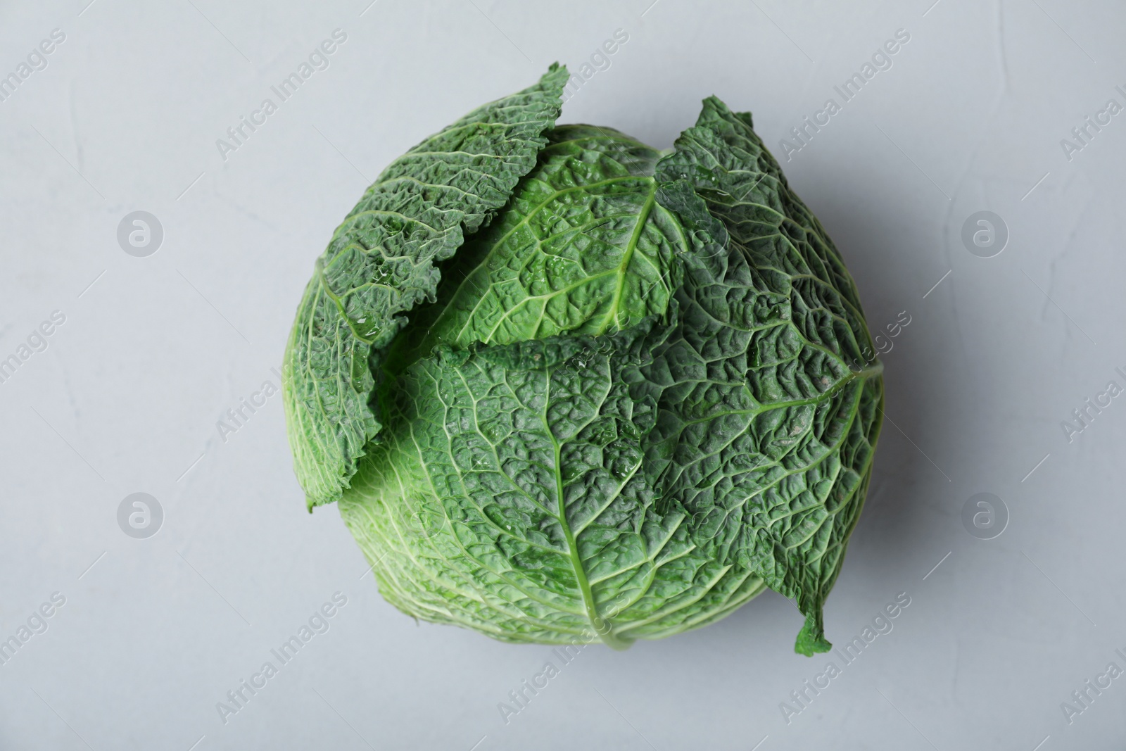 Photo of Savoy cabbage on grey background, top view