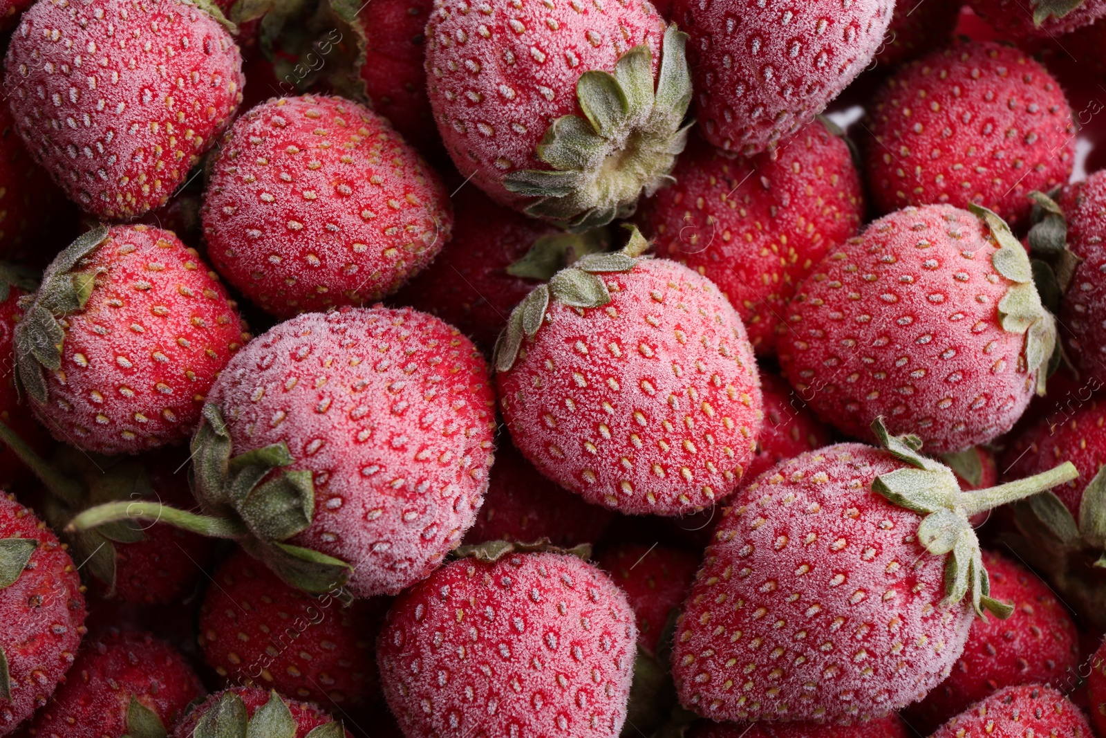 Photo of Tasty frozen strawberries as background, top view