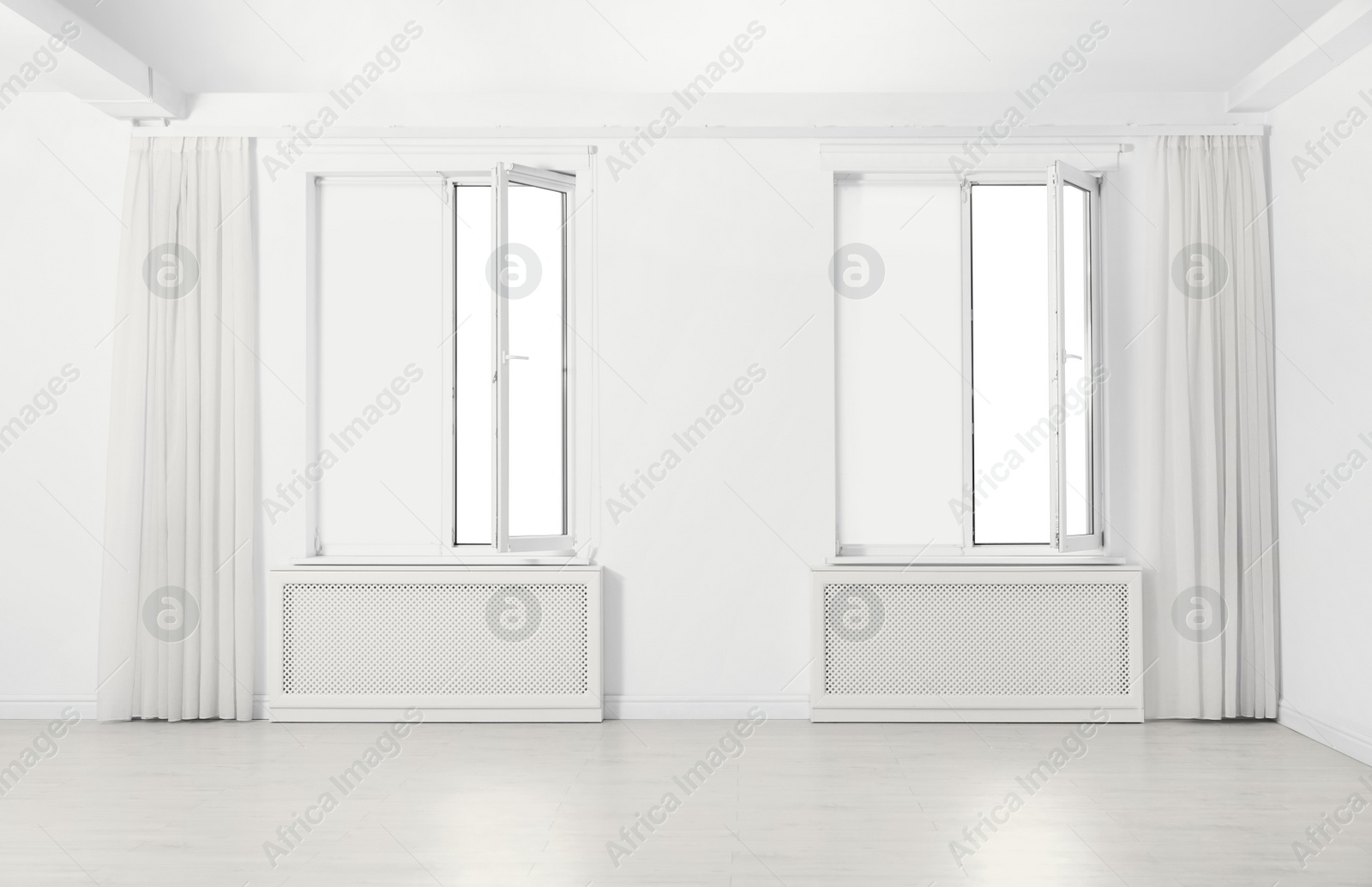 Photo of Windows with elegant curtains and blinds in empty room