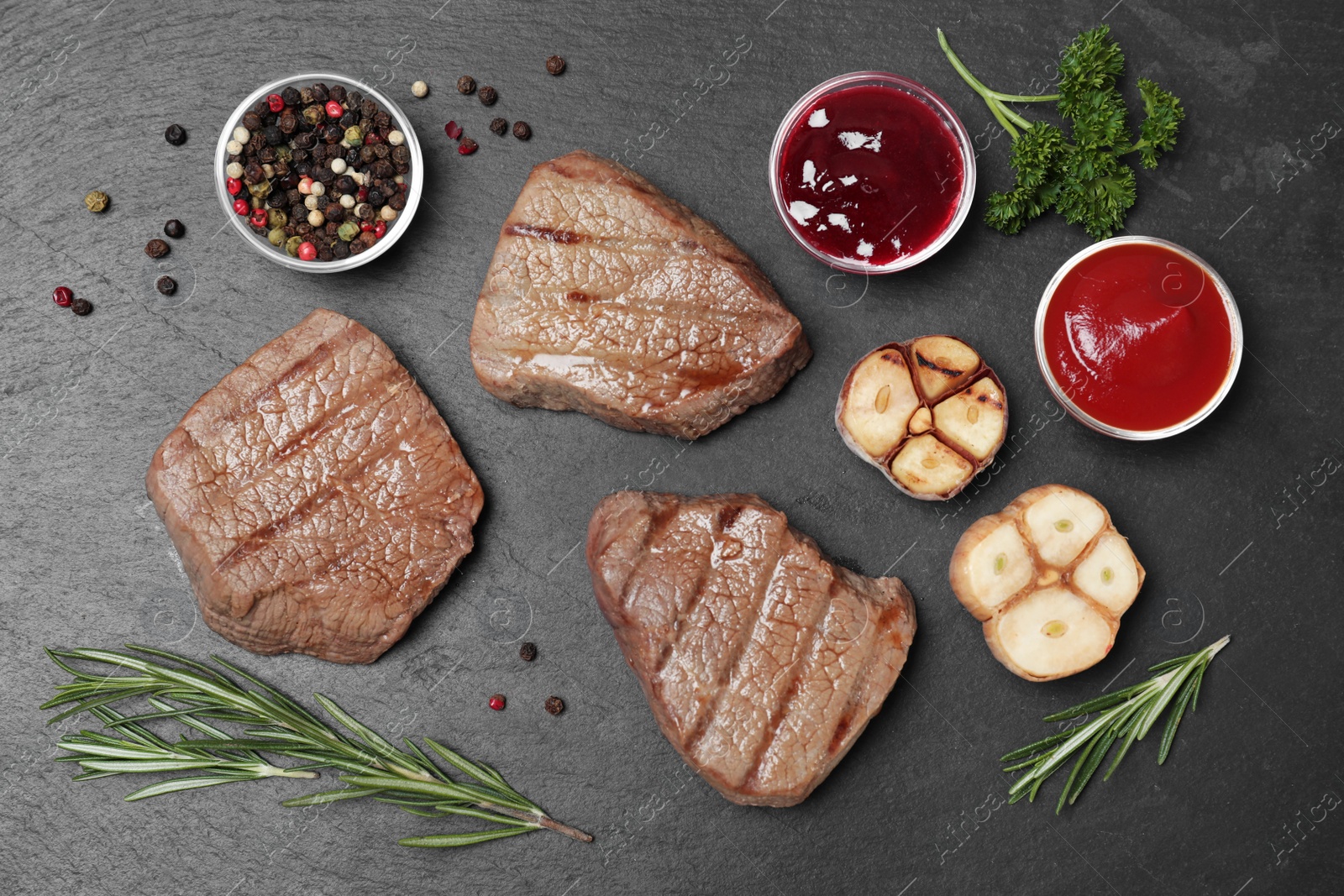 Photo of Flat lay composition with grilled meat on slate plate