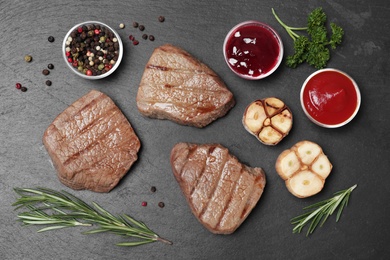 Flat lay composition with grilled meat on slate plate