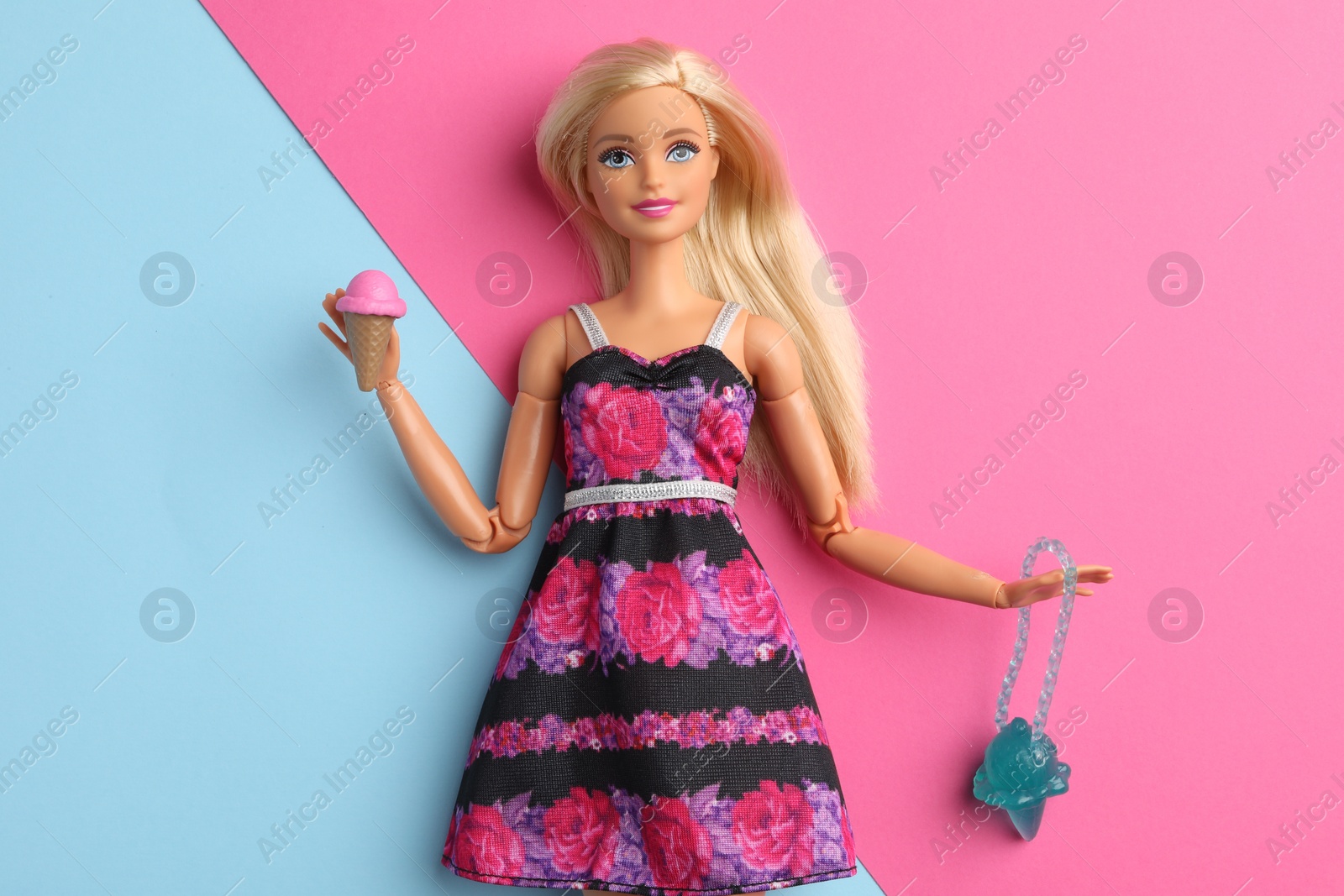 Photo of Mykolaiv, Ukraine - September 4, 2023: Beautiful Barbie doll with ice cream and bag on color background