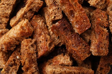 Delicious crispy rusks as background, closeup view