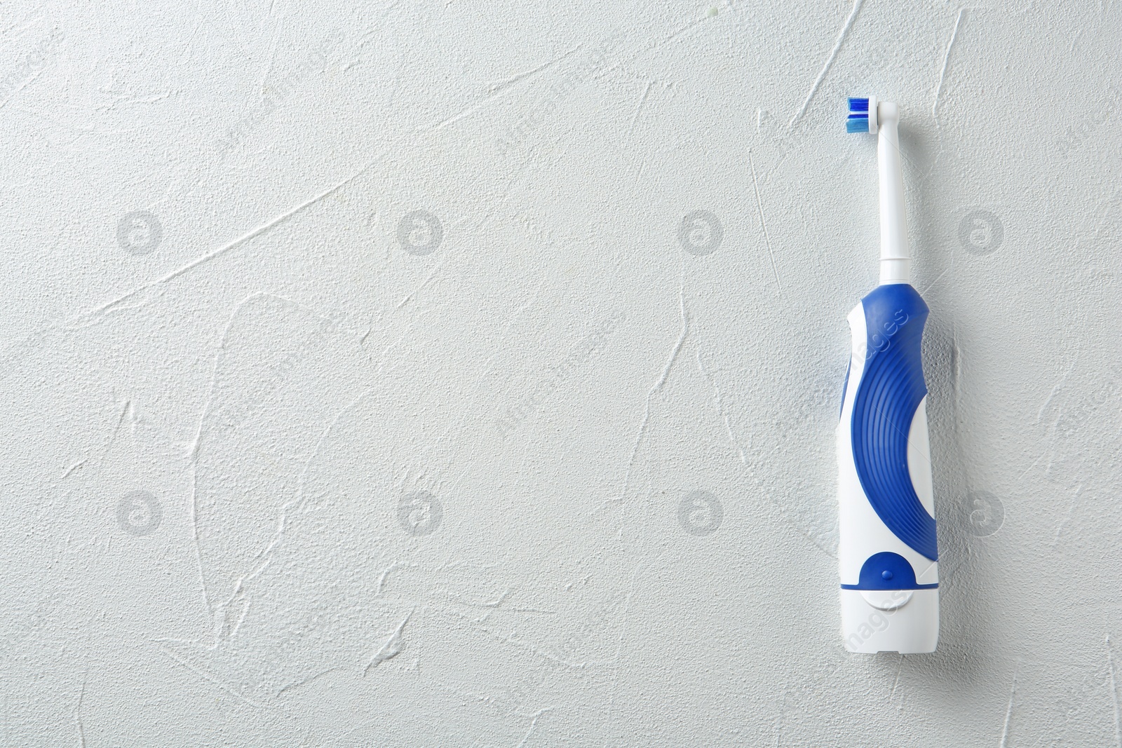 Photo of Electric toothbrush on light background. Dental care